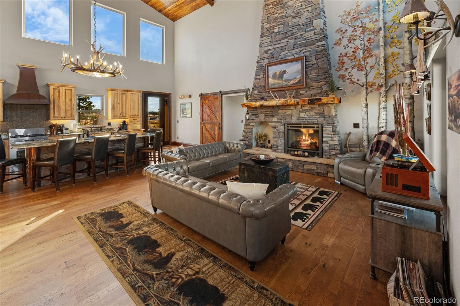 12875 Holmes Road Colorado Springs, CO 80908 - Photo 5 of 50 a living room with furniture a fireplace and a flat screen tv
