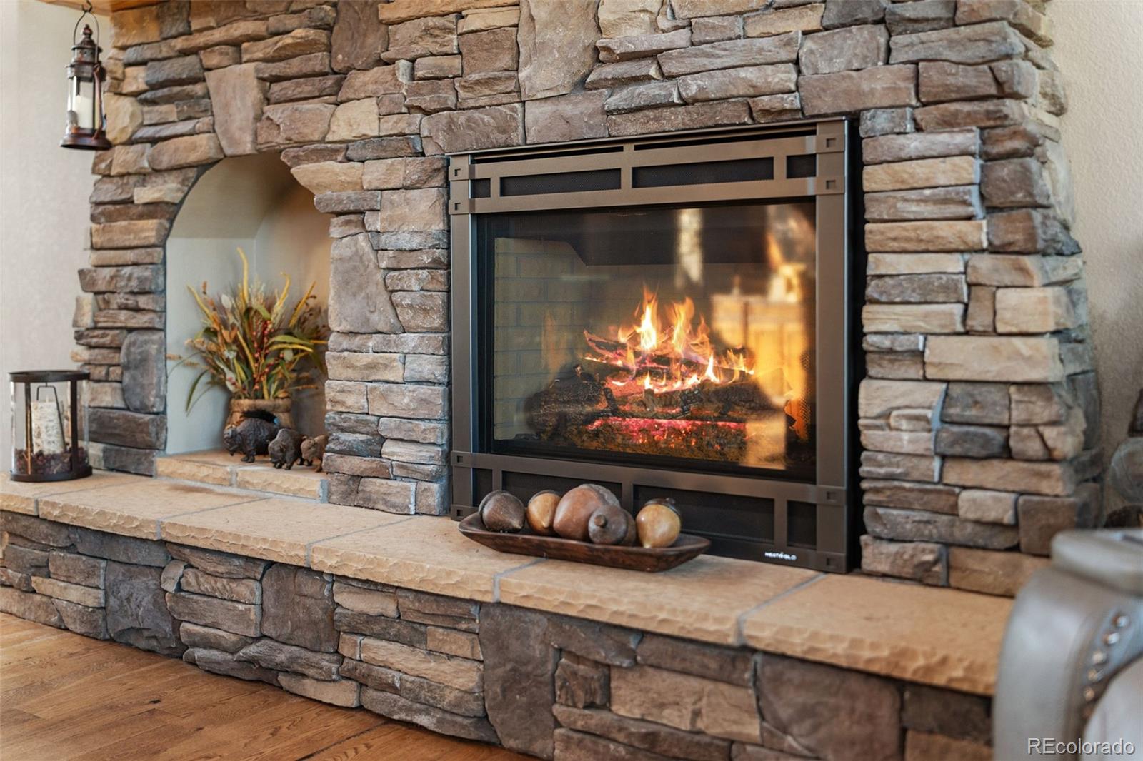 12875 Holmes Road Colorado Springs, CO 80908 - Photo 6 of 50 a living room with fireplace furniture and a flat screen tv