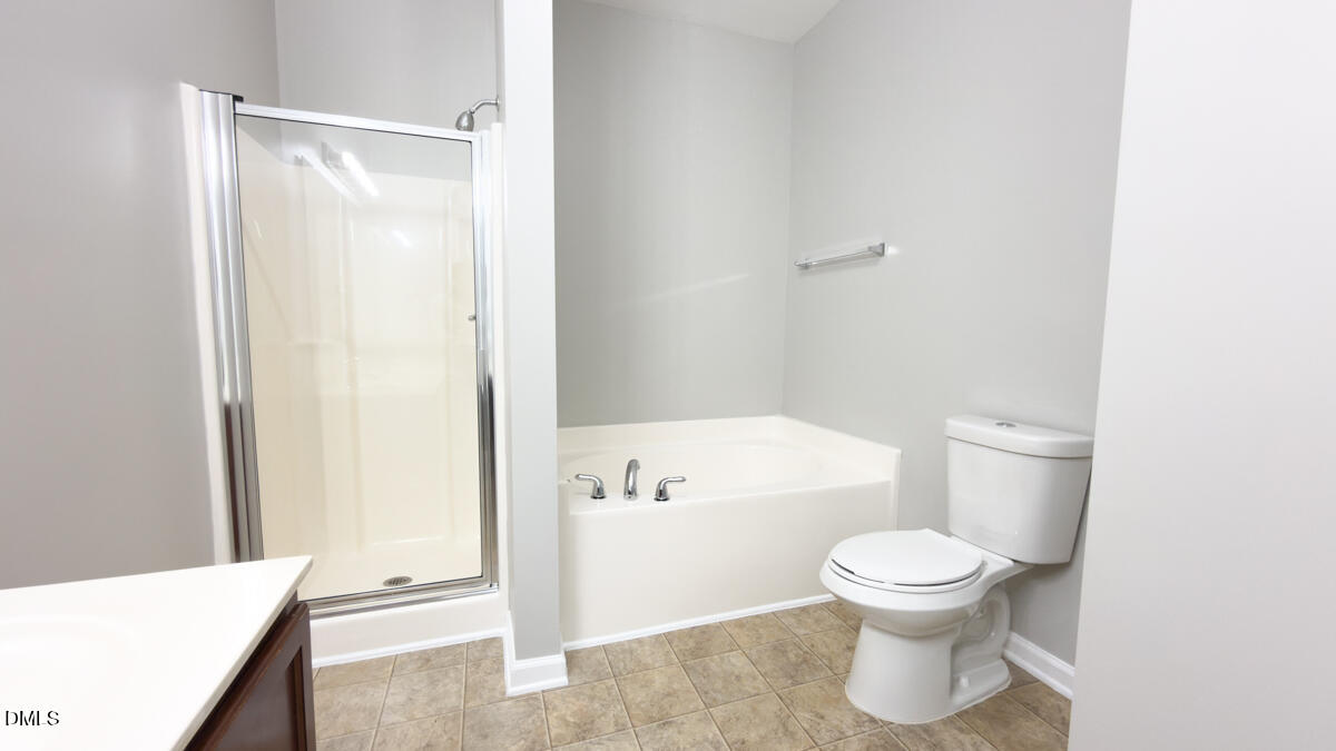 2608 Follow Me Way Raleigh, NC 27610 - Photo 11 of 32 a white toilet sitting next to a bathroom sink