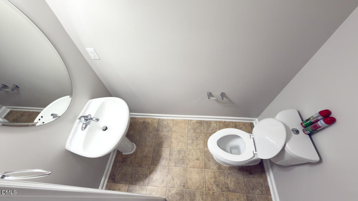 2608 Follow Me Way Raleigh, NC 27610 - Photo 13 of 32 a bathroom with a toilet and a mirror