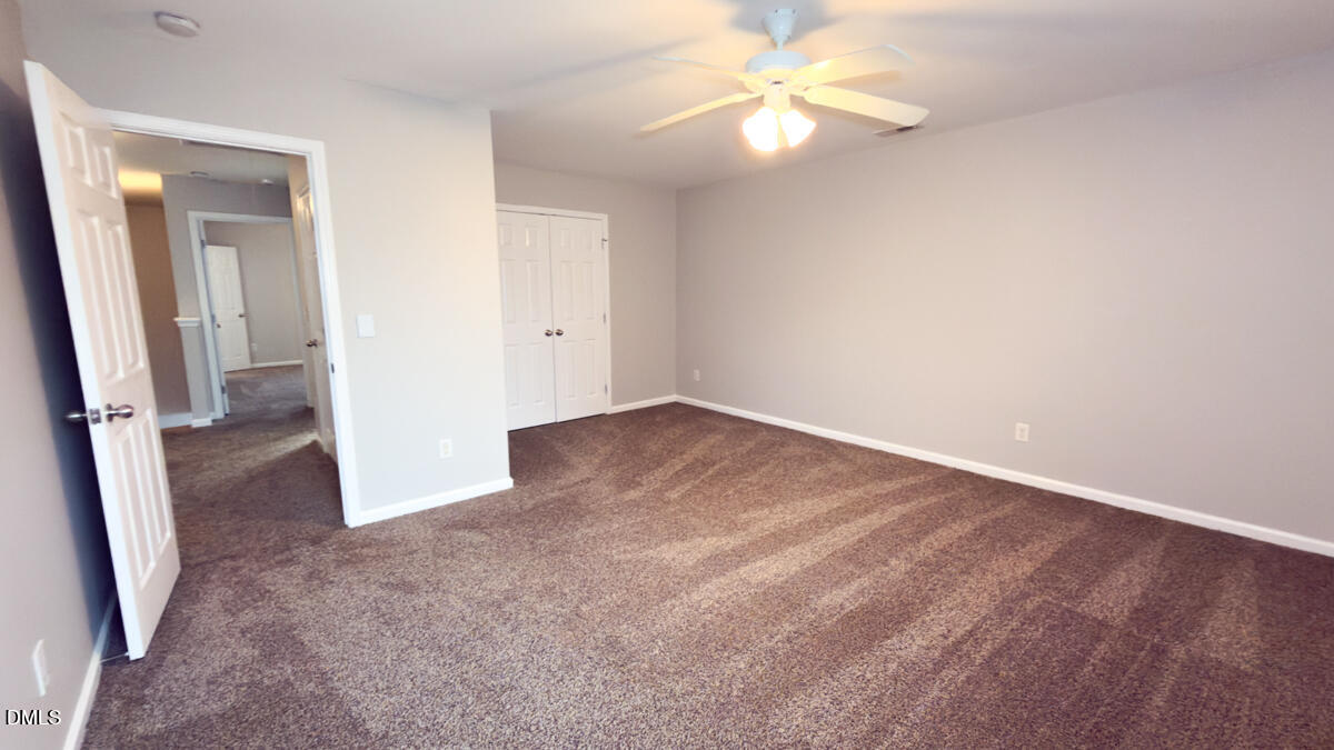 2608 Follow Me Way Raleigh, NC 27610 - Photo 16 of 32 an empty room with fan and entrance