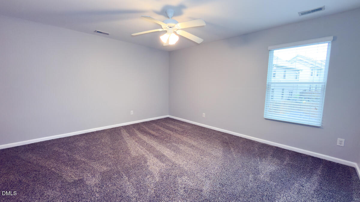 2608 Follow Me Way Raleigh, NC 27610 - Photo 21 of 32 an empty room with a window and a fan