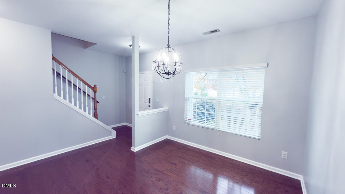 2608 Follow Me Way Raleigh, NC 27610 - Photo 3 of 32 a view of an empty room with wooden floor and a window