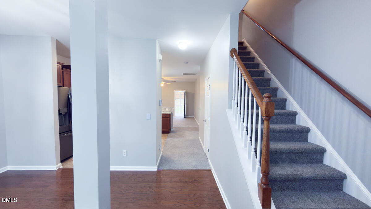 2608 Follow Me Way Raleigh, NC 27610 - Photo 5 of 32 a view of a hallway with wooden floor and entryway