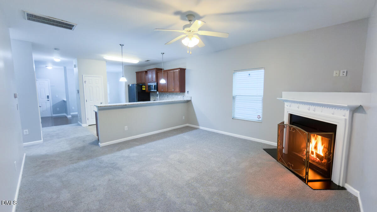 2608 Follow Me Way Raleigh, NC 27610 - Photo 8 of 32 a view of an empty room with a fireplace