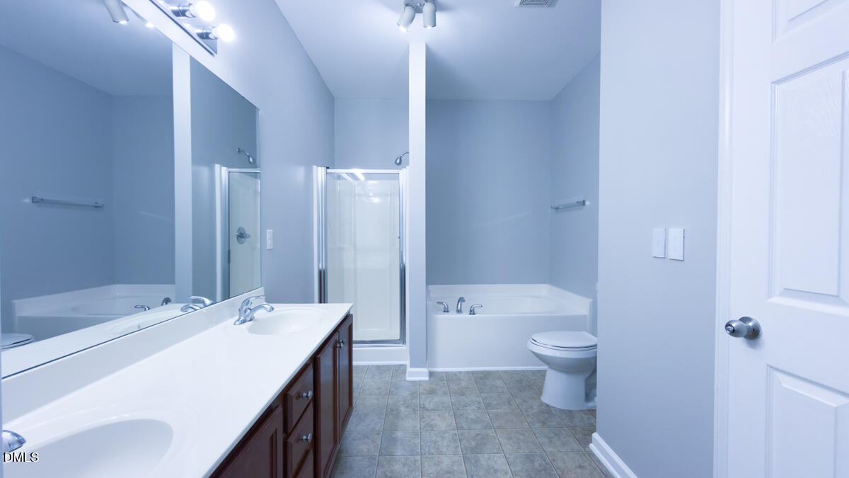 2608 Follow Me Way Raleigh, NC 27610 - Photo 10 of 32 a bathroom with a sink a toilet and shower