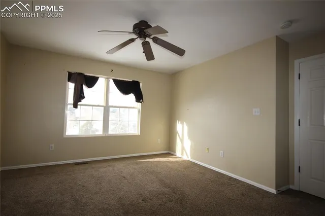 a view of an empty room and a window