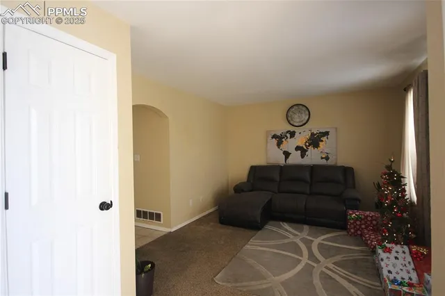 a view of a livingroom with furniture and natural light
