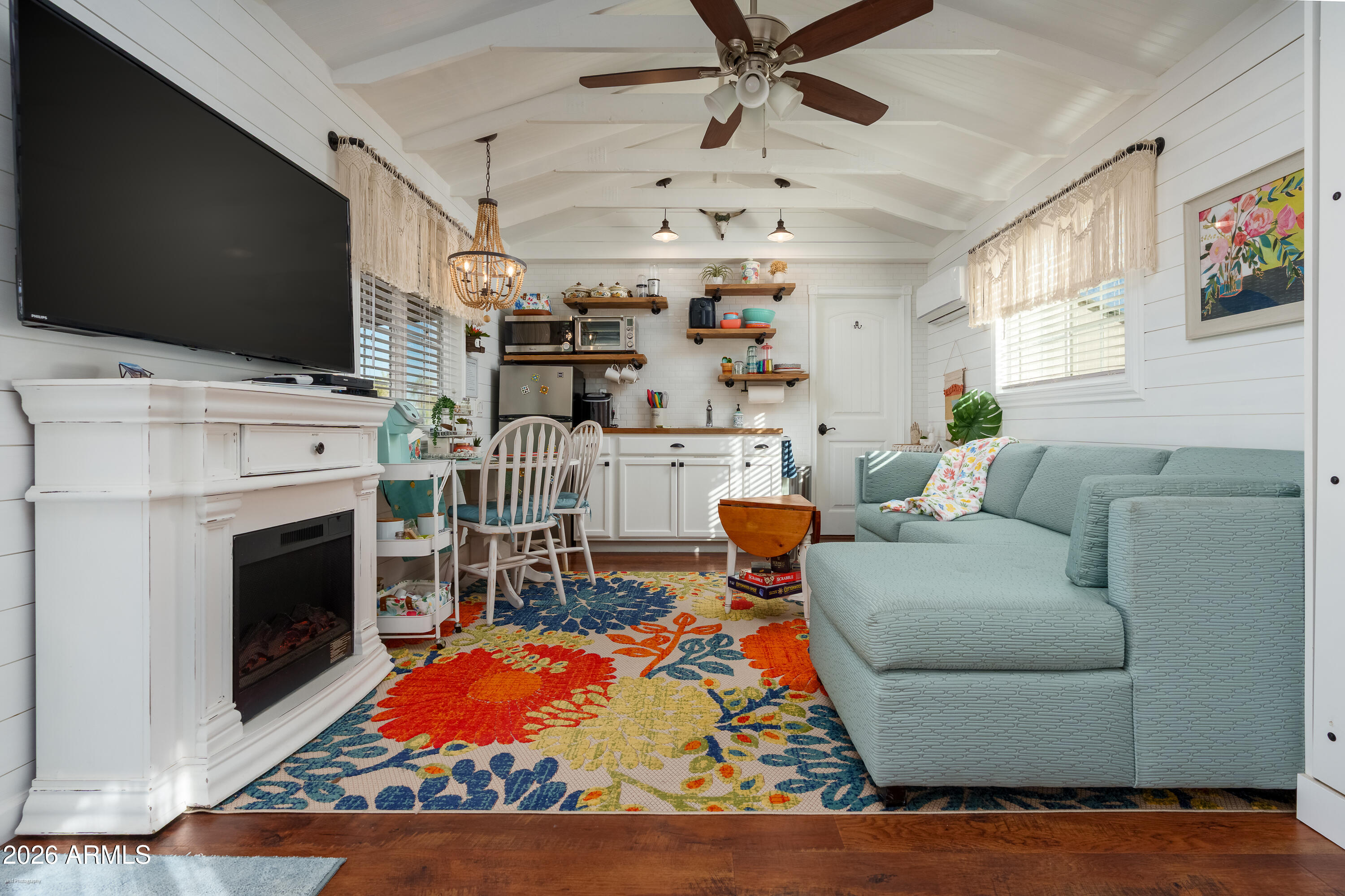 4550 Hopewell Mine Road Clarkdale, AZ 86324 - Photo 72 of 97 a living room with furniture a flat screen tv and a fireplace