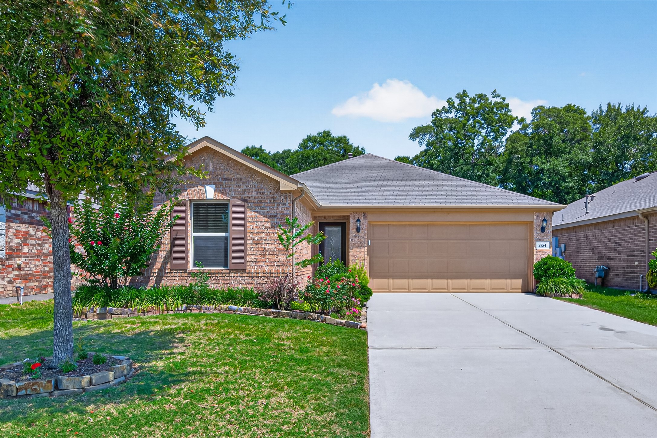 2754 Cayden Creek Way Conroe, TX 77304 - Photo 39 of 40 a front view of house with yard and trees