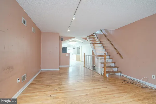 a view of entryway and hall with wooden floor