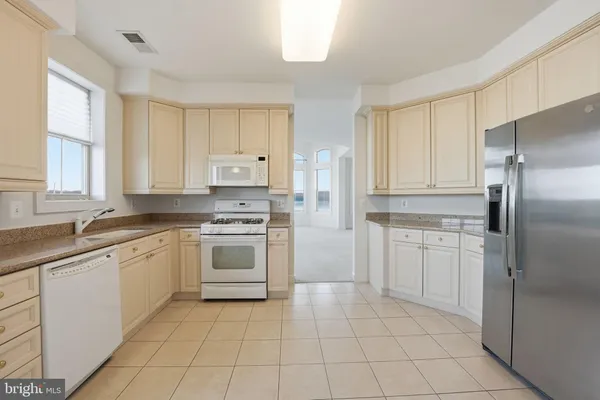 a kitchen with a stove sink and refrigerator