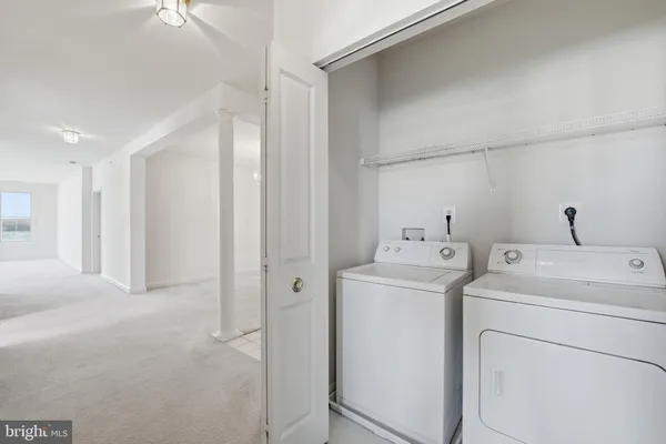 a view of storage and utility room with washer and dryer