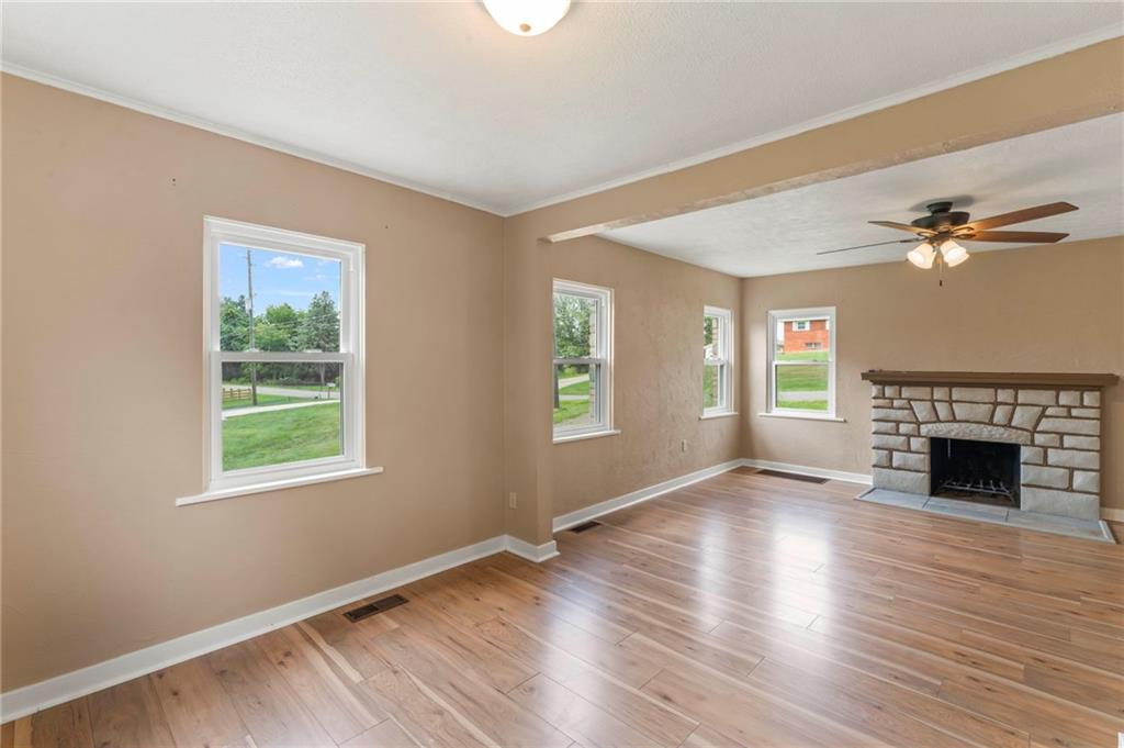34 Meyers Road Washington, PA 15301 - Photo 13 of 34 an empty room with wooden floor fireplace and windows