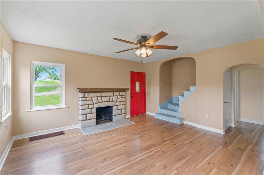34 Meyers Road Washington, PA 15301 - Photo 8 of 34 an empty room with windows fireplace and a wooden floor