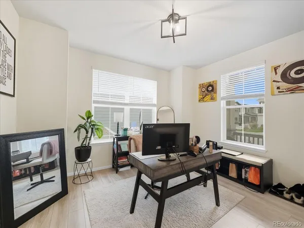 a living room with furniture a window and a flat screen tv