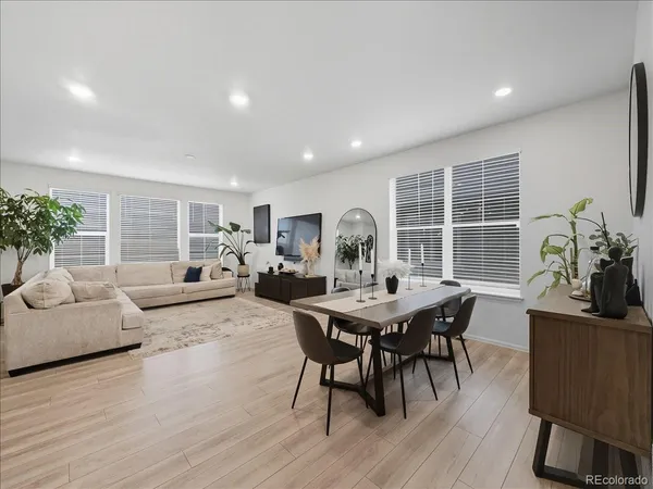 a view of a dining room with furniture and wooden floor