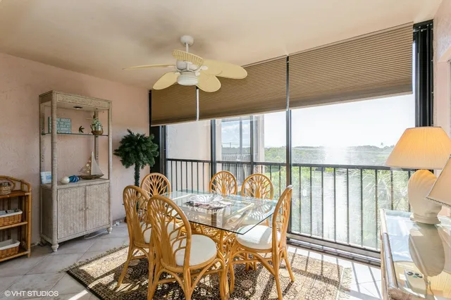 a dining room with furniture a chandelier and wooden floor