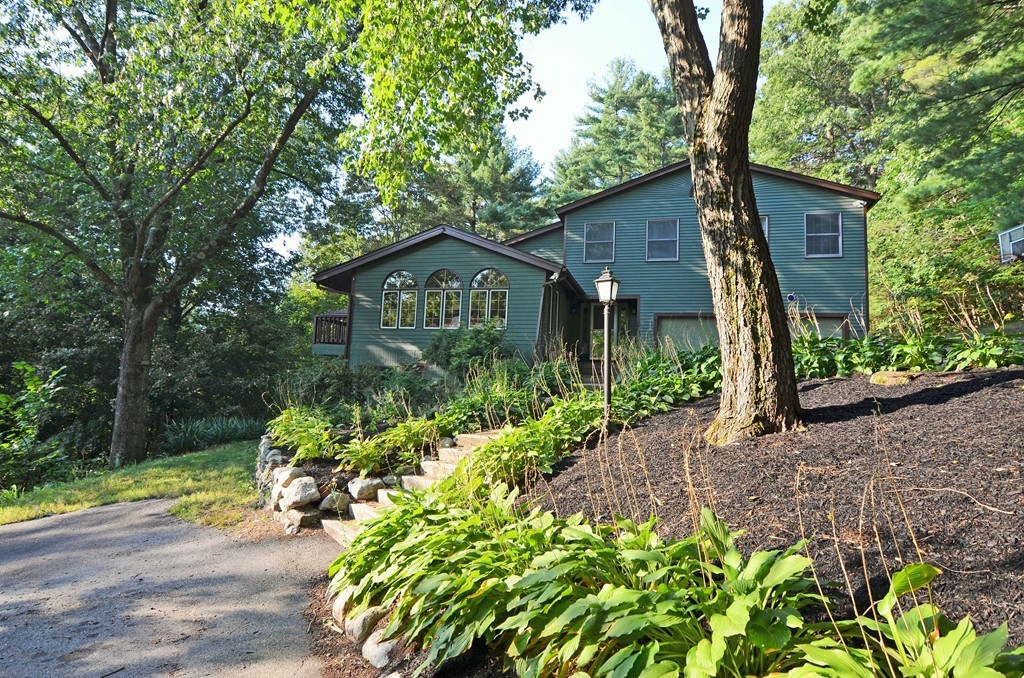 a front view of a house with a yard and outdoor seating