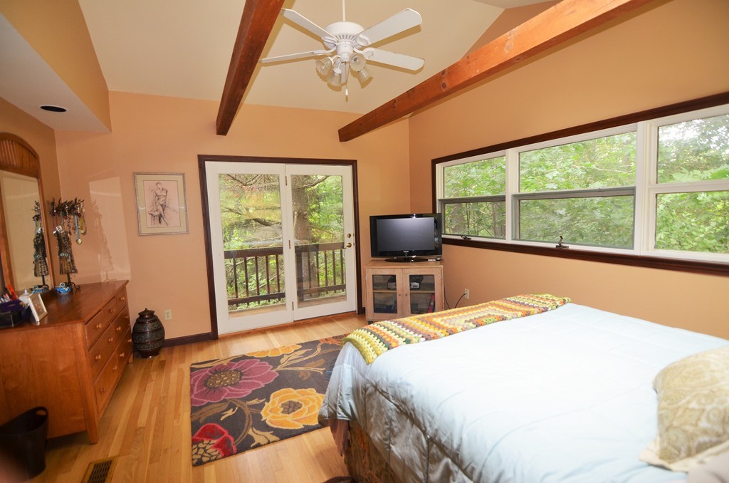 17 Oak Hill Road Harvard, MA 01451 - Photo 13 of 28 a bedroom with a bed and a chair next to a window