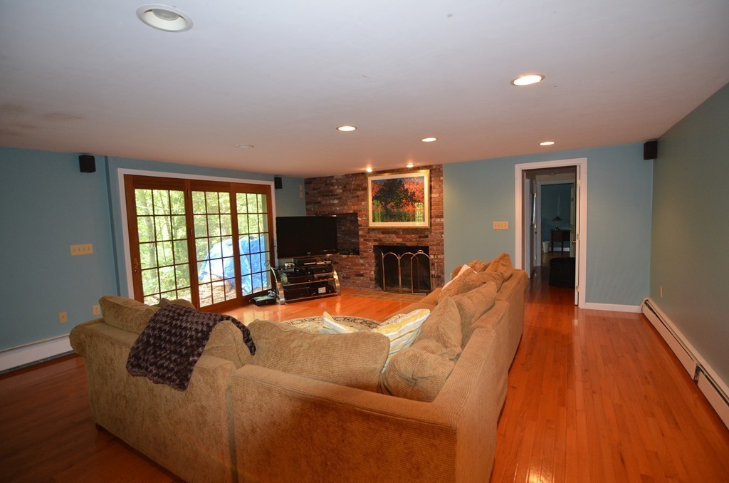 17 Oak Hill Road Harvard, MA 01451 - Photo 19 of 28 a living room with furniture a flat screen tv and a large window