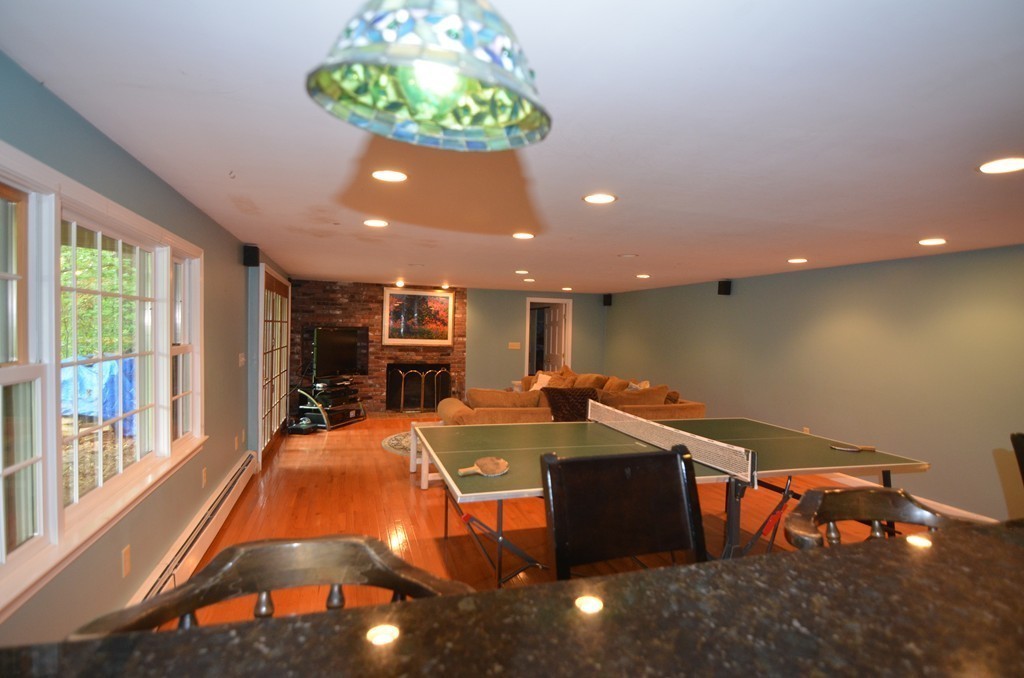 17 Oak Hill Road Harvard, MA 01451 - Photo 22 of 28 a living room with furniture a table and a chandelier