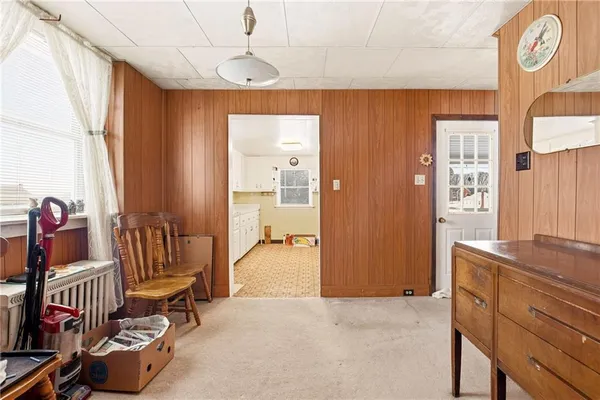 walk in closet with window and chandelier