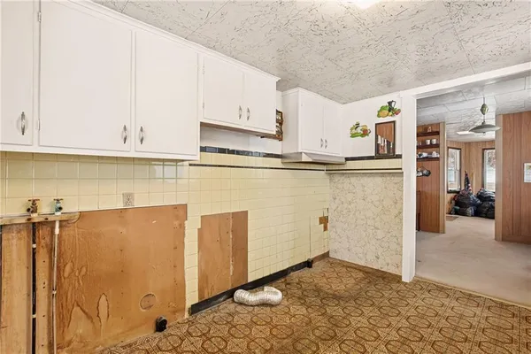 a view of kitchen with refrigerator and window