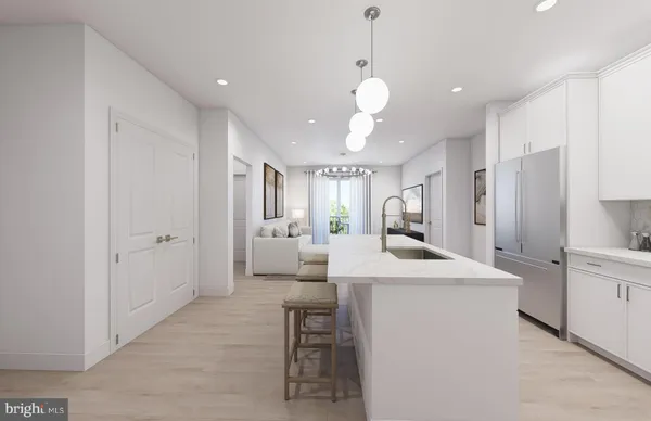 a large white kitchen with a stove a sink a dining table and chairs