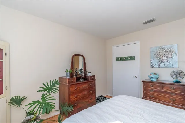 a room with a bed and wooden floor