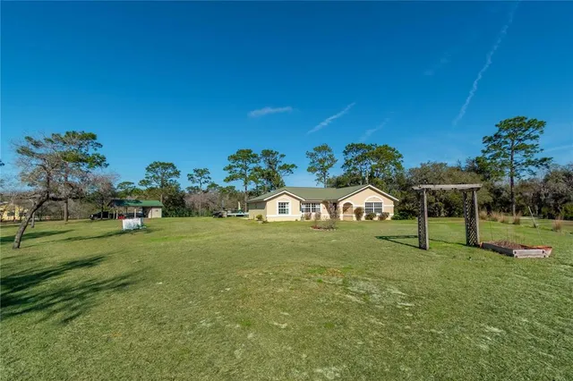 a view of a house with swimming pool and sitting area