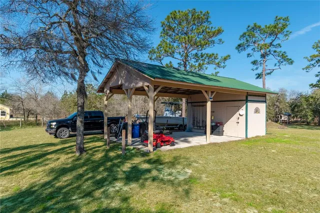 an aerial view of a house with swimming pool and big yard