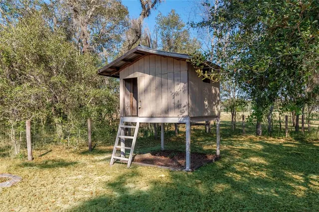 an aerial view of a house with swimming pool a yard and a yard