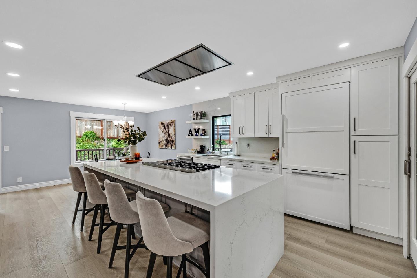 19 Elk Court Pacifica, CA 94044 - Photo 11 of 45 a kitchen with kitchen island a stove a table a sink and cabinets