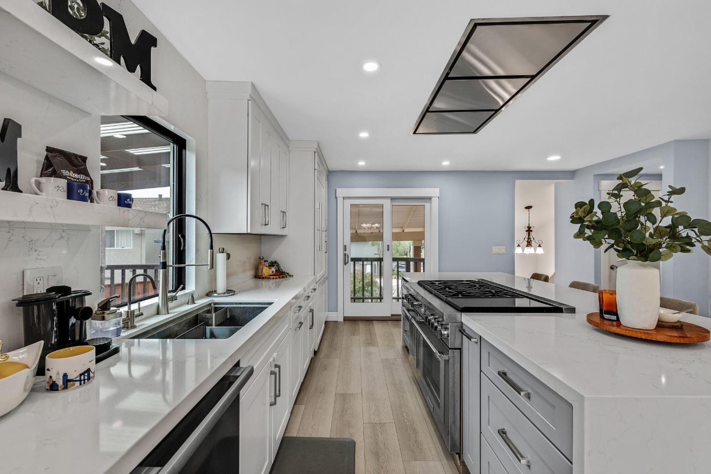 19 Elk Court Pacifica, CA 94044 - Photo 13 of 45 a kitchen with kitchen island stainless steel appliances a sink a stove and cabinets