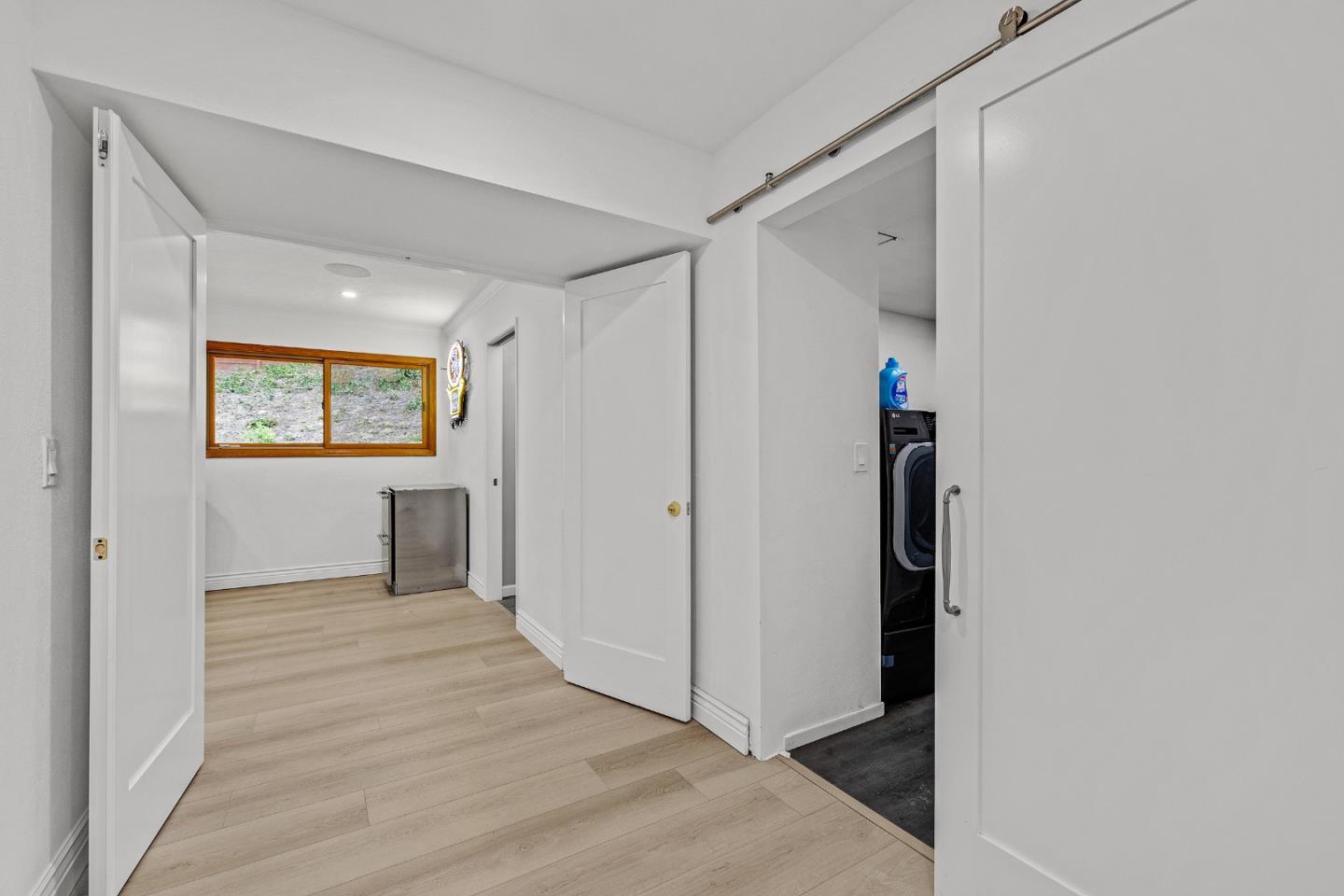 19 Elk Court Pacifica, CA 94044 - Photo 25 of 45 a view of a hallway with wooden floor and a bathroom