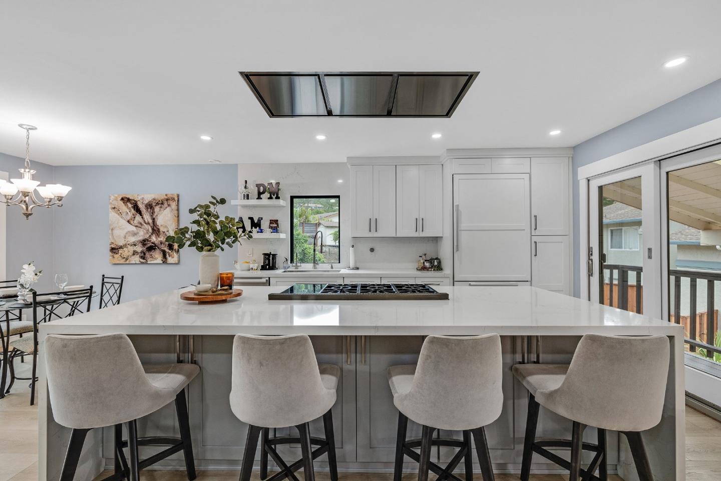 19 Elk Court Pacifica, CA 94044 - Photo 10 of 45 a kitchen with stainless steel appliances granite countertop a table chairs stove and cabinets