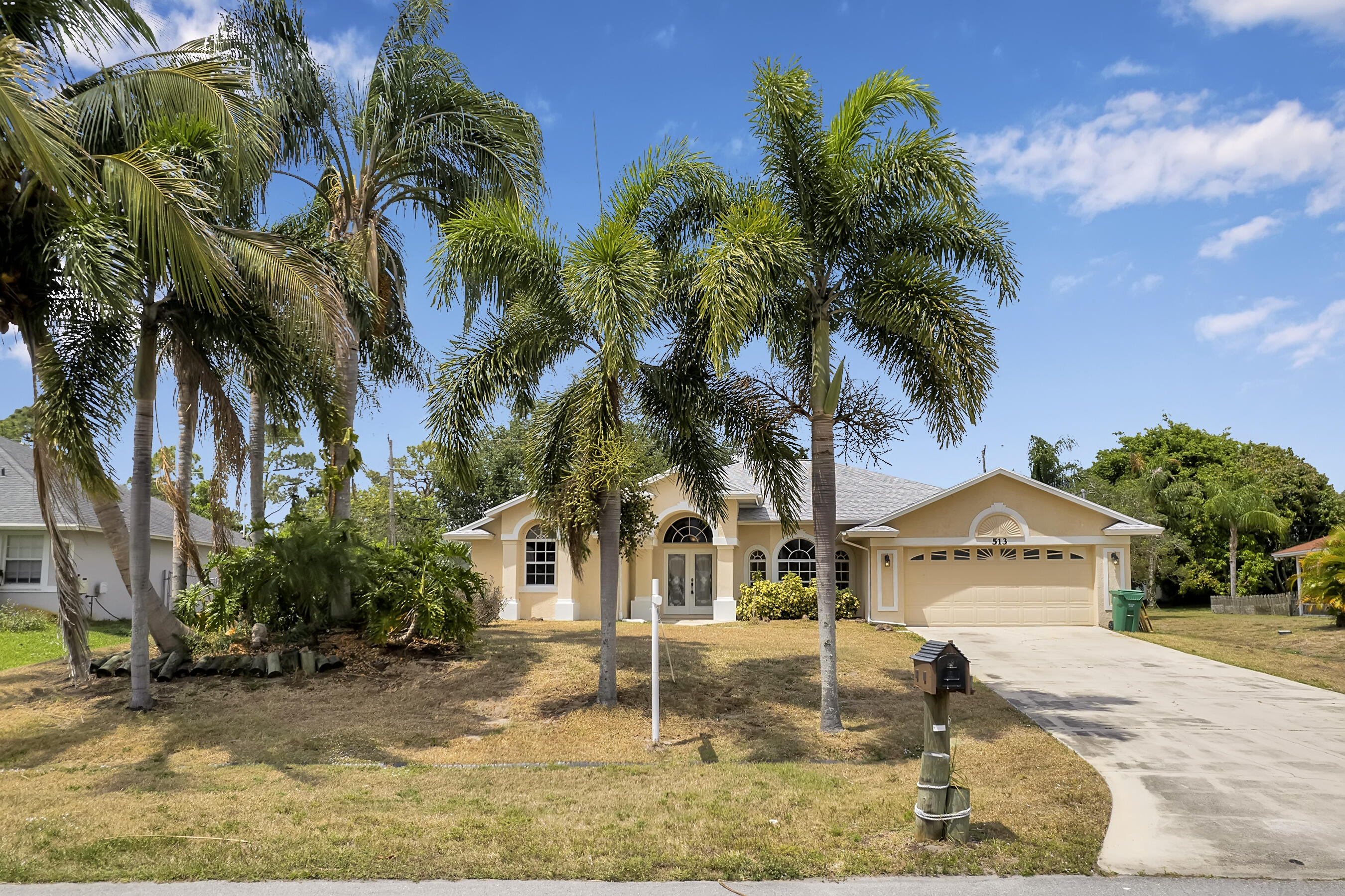 513 Southeast Cliff Road Port St. Lucie, FL 34984 - Photo 1 of 39 a view of a street with palm trees