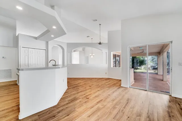 a view of empty room with wooden floor and outdoor view