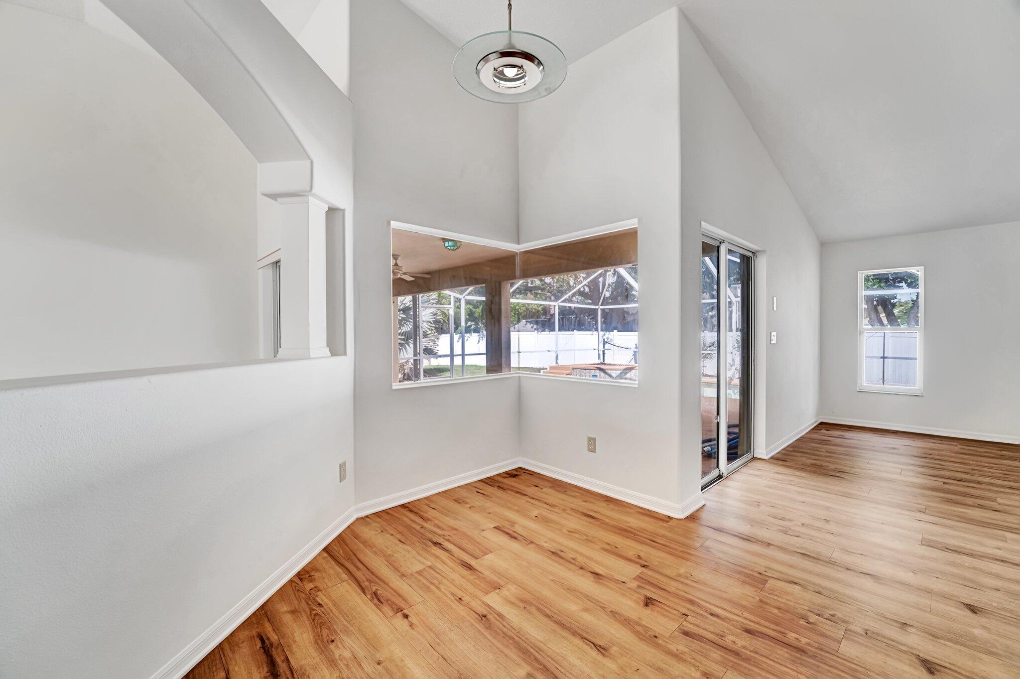 513 Southeast Cliff Road Port St. Lucie, FL 34984 - Photo 14 of 39 a view of empty room with wooden floor and fan