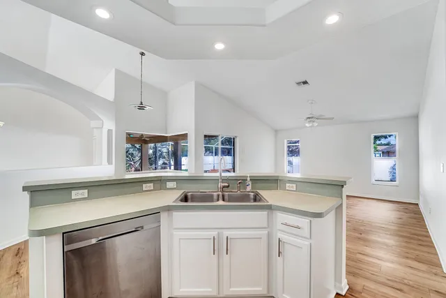 a kitchen with a sink stove and cabinets
