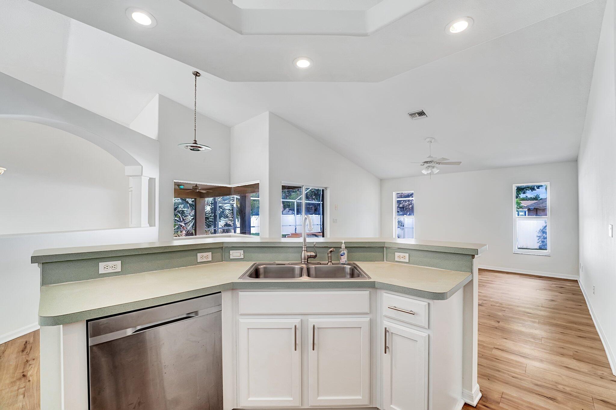 513 Southeast Cliff Road Port St. Lucie, FL 34984 - Photo 18 of 39 a kitchen with a sink stove and cabinets