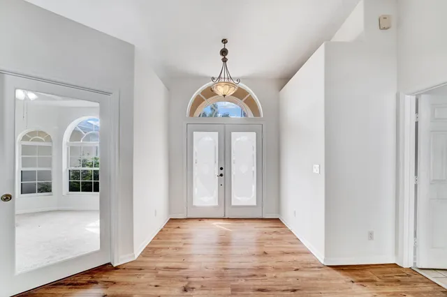 a view of an entryway with wooden floor