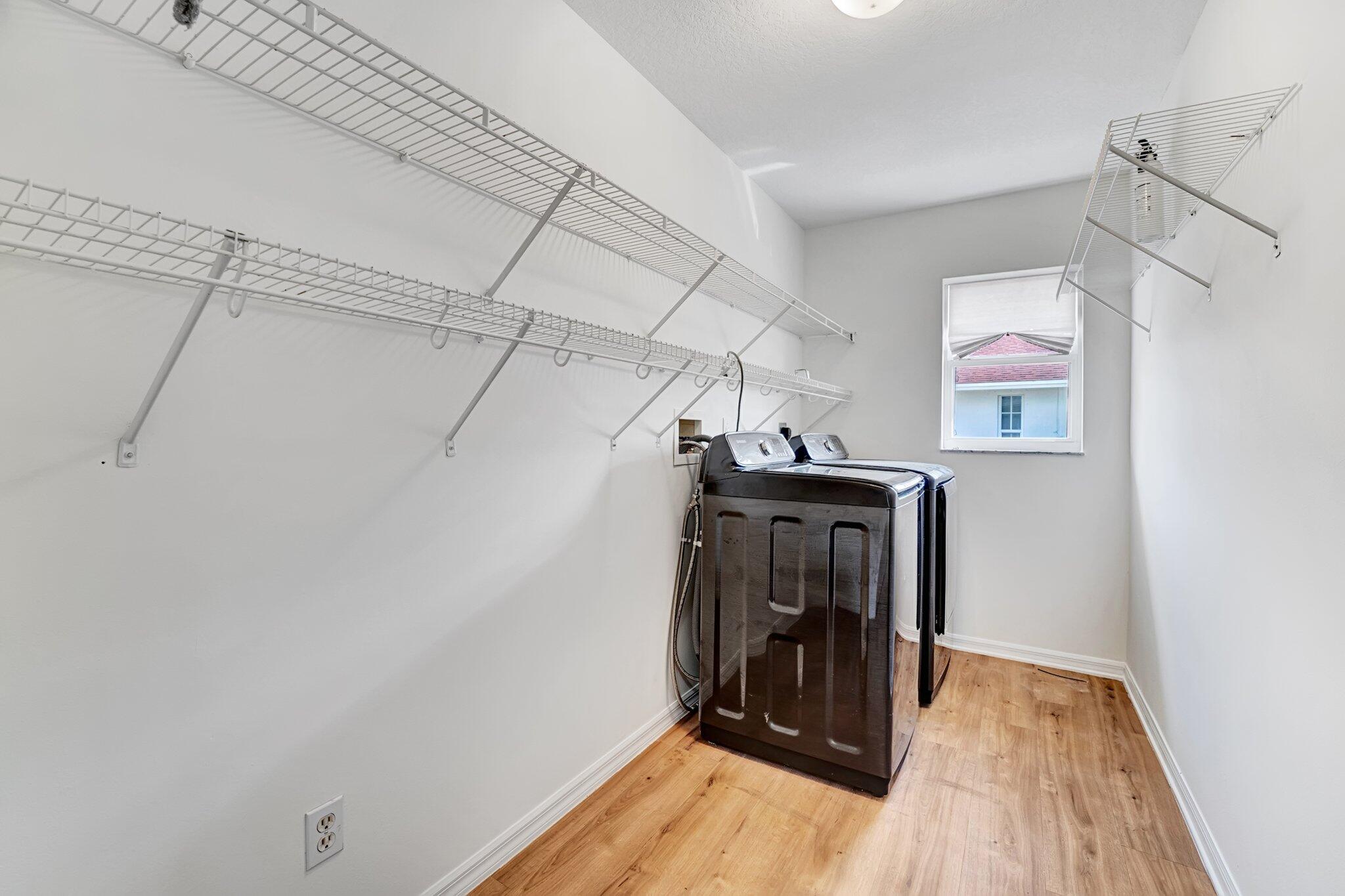 513 Southeast Cliff Road Port St. Lucie, FL 34984 - Photo 21 of 39 a view of a hallway with wooden floor