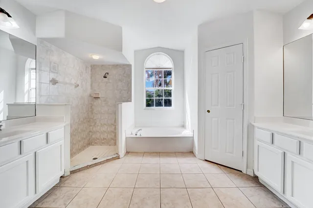 a bathroom with a bathtub and a shower
