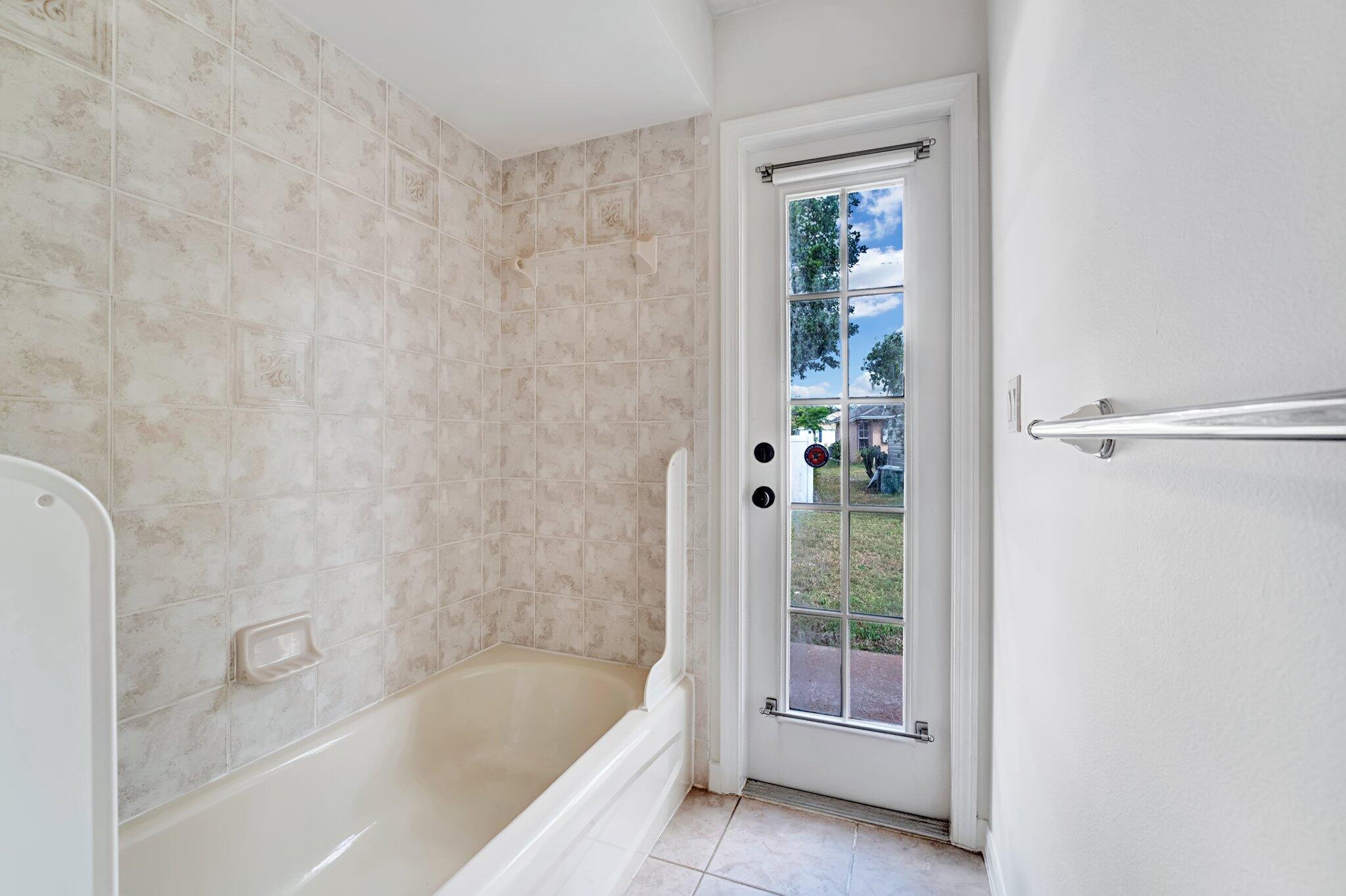 513 Southeast Cliff Road Port St. Lucie, FL 34984 - Photo 29 of 39 a bathroom with a bathtub and shower