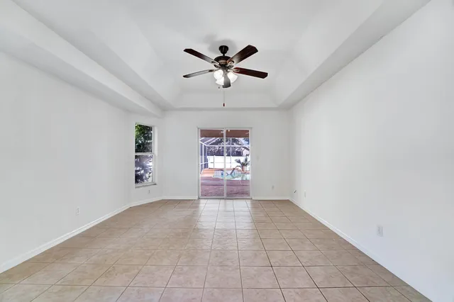 a view of a livingroom with a ceiling fan and window