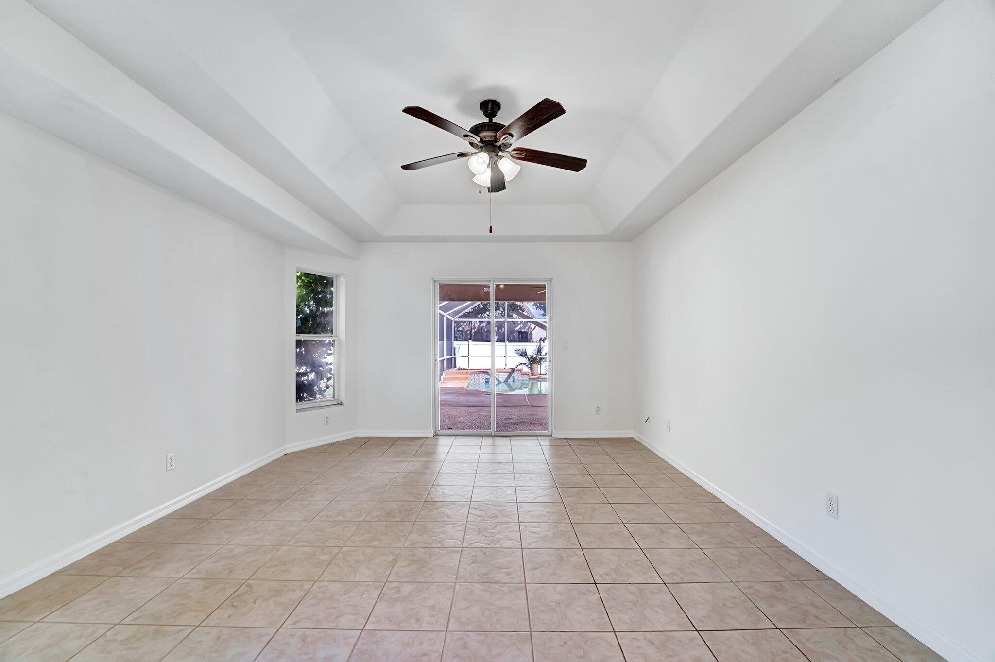 513 Southeast Cliff Road Port St. Lucie, FL 34984 - Photo 30 of 39 a view of a livingroom with a ceiling fan and window