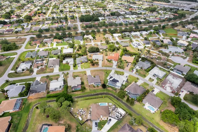 an aerial view of residential houses with yard