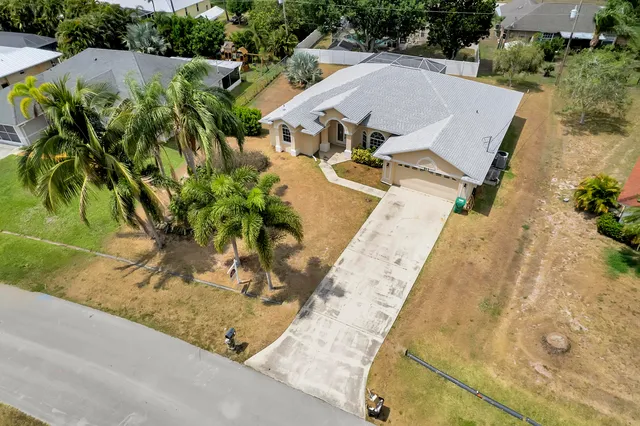 an aerial view of a house with a yard and sitting area